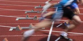 Starting Signal Several Sprinter are starting side by side from starting blocks.